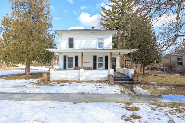 view of front of property with covered porch and fence