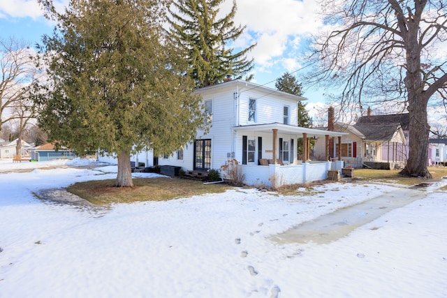 view of front of house featuring covered porch and a chimney