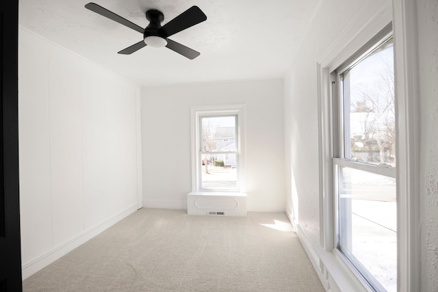 carpeted spare room with a textured ceiling and a ceiling fan