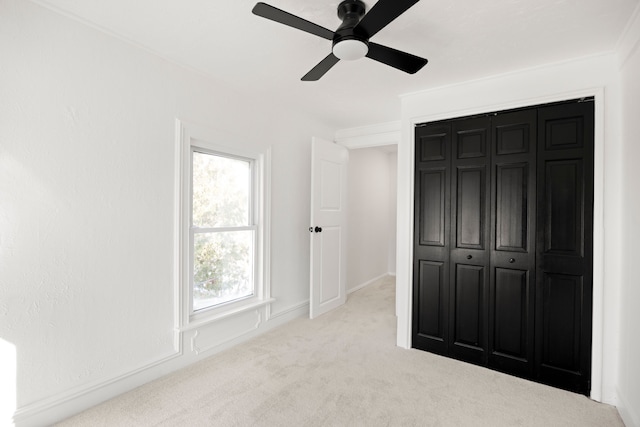 unfurnished bedroom featuring a ceiling fan and carpet flooring