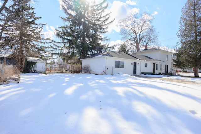 view of snowy exterior featuring an outbuilding