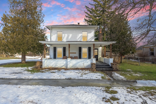 view of front of property with fence and a porch