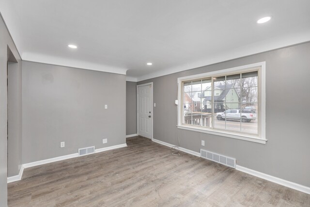 empty room with recessed lighting, visible vents, baseboards, and wood finished floors