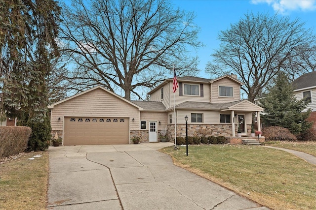 view of front of home with a garage, stone siding, a front yard, and driveway