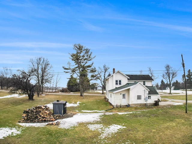 view of side of property with a lawn