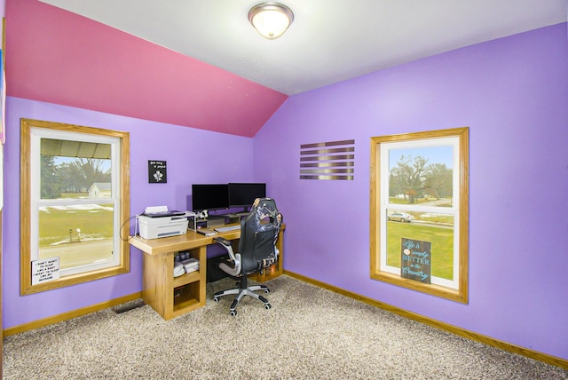 carpeted office space featuring lofted ceiling and baseboards