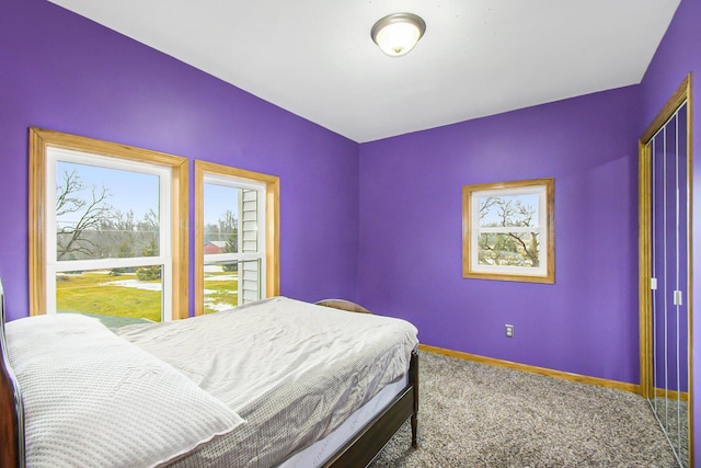 bedroom with carpet flooring and baseboards