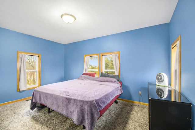 bedroom featuring carpet and baseboards