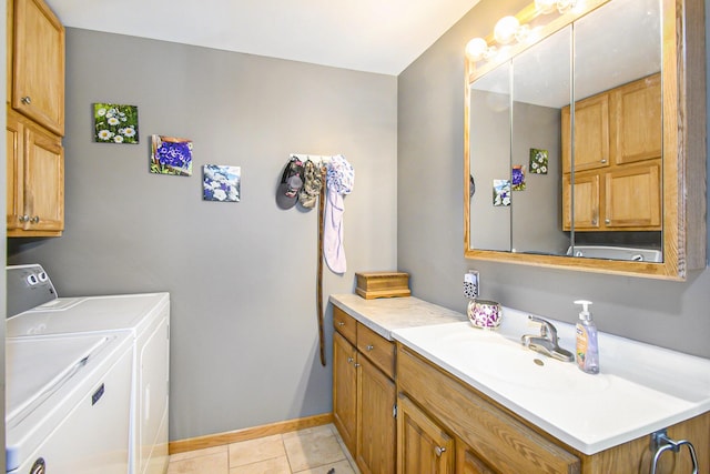 bathroom with washer and dryer, tile patterned flooring, vanity, and baseboards