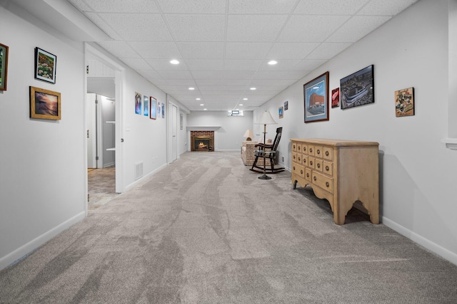 corridor featuring carpet floors, recessed lighting, a paneled ceiling, visible vents, and baseboards