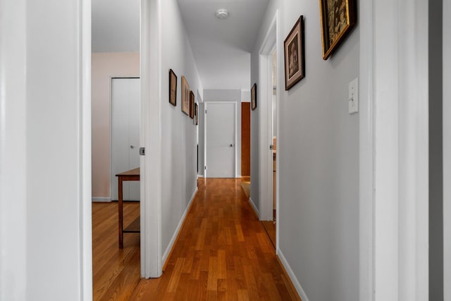 hall with wood finished floors and baseboards