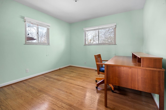 office space featuring baseboards and wood finished floors