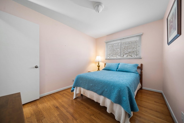 bedroom featuring wood finished floors and baseboards