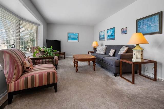 carpeted living room with baseboards