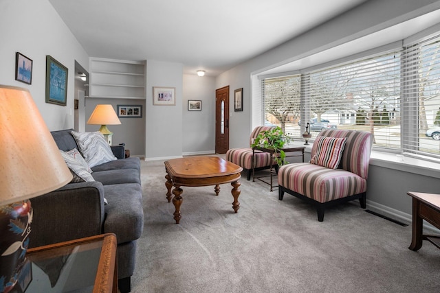 carpeted living room featuring visible vents and baseboards