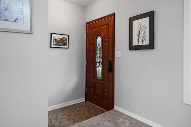 entryway with carpet and baseboards