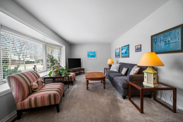 carpeted living area featuring baseboards