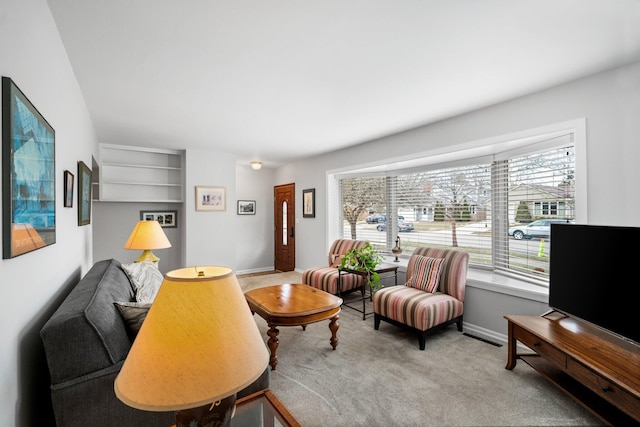 carpeted living room featuring baseboards