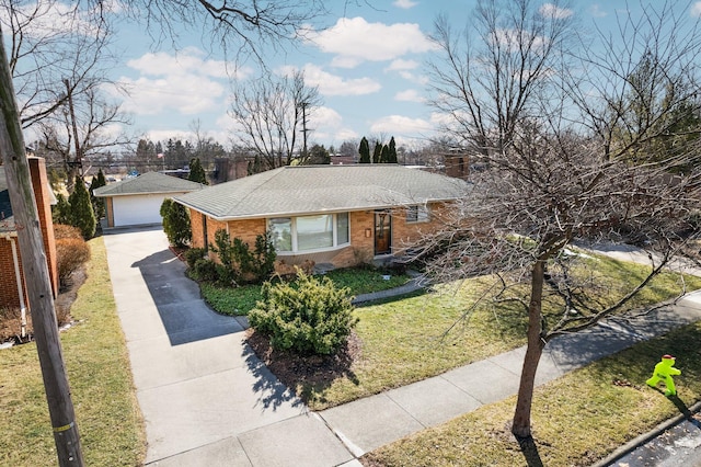 single story home with an outbuilding, brick siding, a detached garage, a chimney, and a front yard