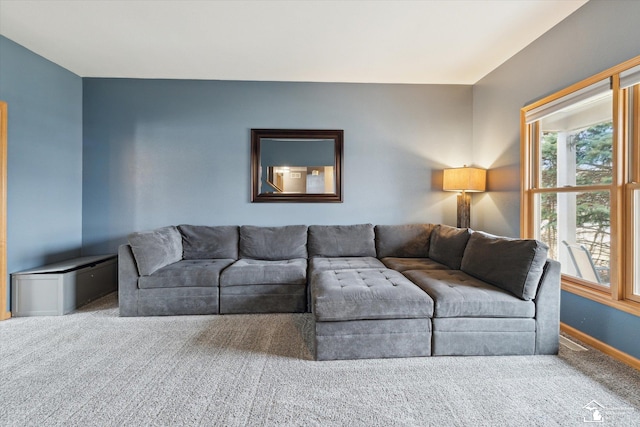 carpeted living area featuring baseboards