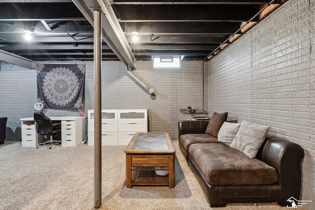 basement featuring carpet flooring and brick wall