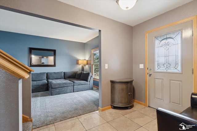 entryway with baseboards and light tile patterned floors