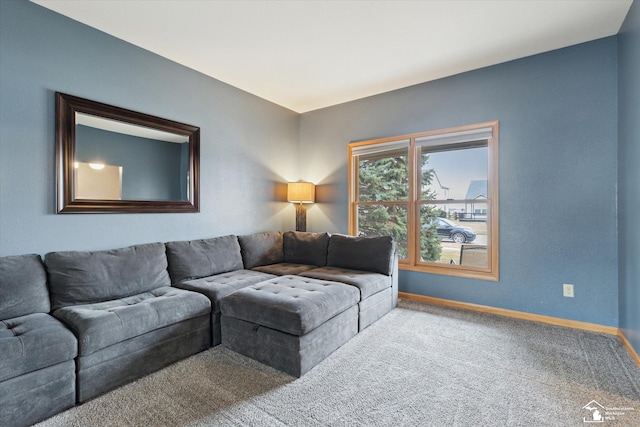 carpeted living room featuring baseboards