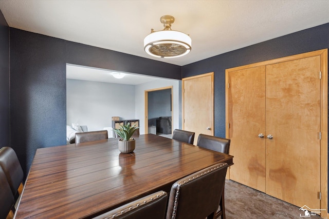 dining area featuring a textured wall