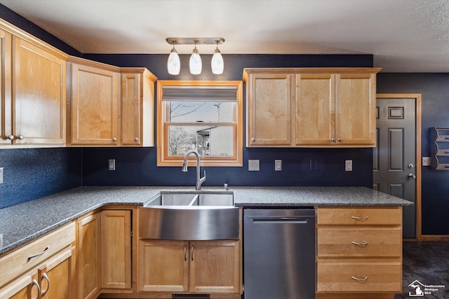 kitchen with dishwasher, light brown cabinetry, dark countertops, and a sink