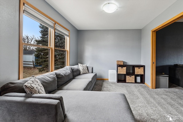 carpeted living room with baseboards