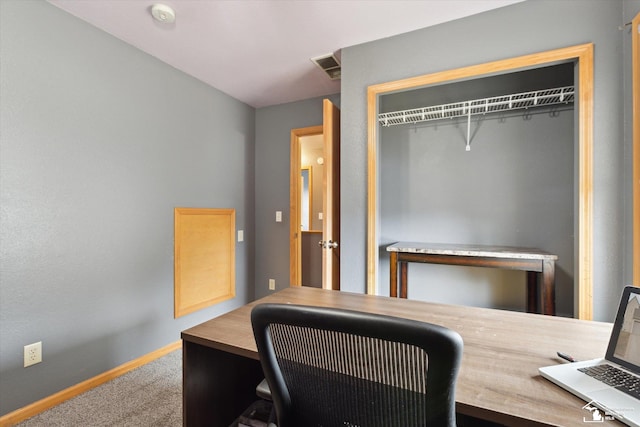 office with carpet flooring, visible vents, and baseboards