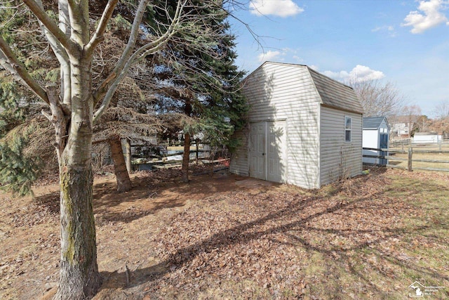 view of shed featuring fence