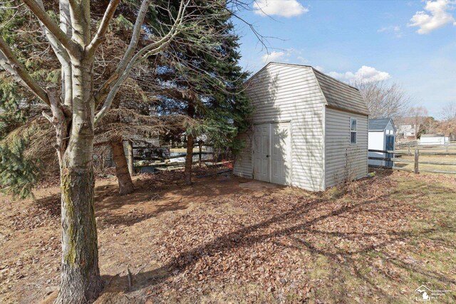 view of shed with fence