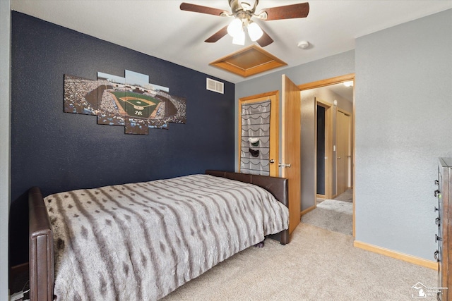 bedroom with attic access, baseboards, visible vents, a ceiling fan, and carpet flooring