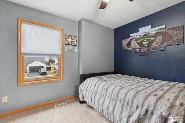 bedroom with carpet, visible vents, ceiling fan, and baseboards