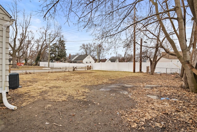 view of yard with cooling unit and fence