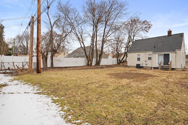 view of yard with entry steps and a fenced backyard