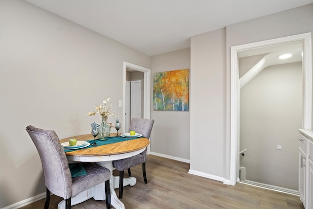 dining room featuring light wood-style floors and baseboards