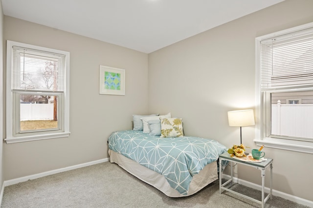 carpeted bedroom featuring baseboards