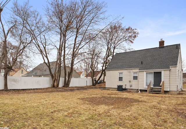2205 Hanford Ave, Lincoln Park, MI 48146 - rear view of property with a chimney, entry steps, central AC unit, and roof with shingles
