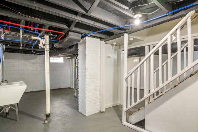 basement featuring stairway and a sink