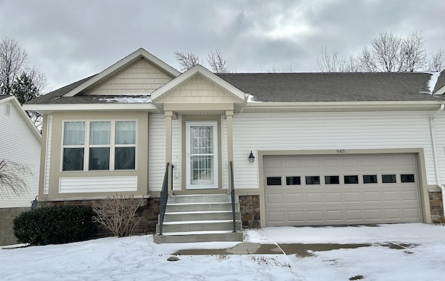 view of front of house featuring a garage and a shingled roof