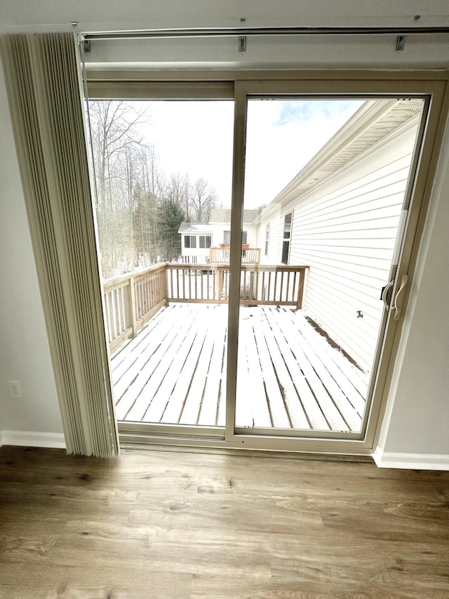 entryway with baseboards, wood finished floors, and a healthy amount of sunlight