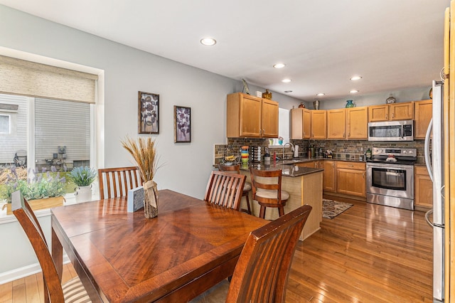 dining room featuring recessed lighting and hardwood / wood-style flooring