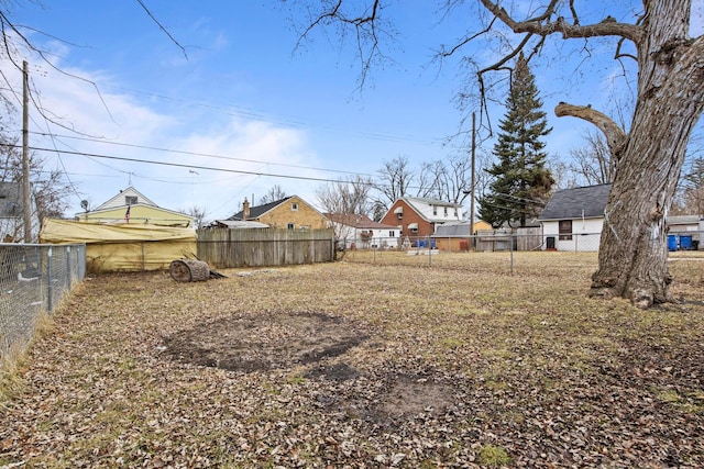 view of yard featuring a fenced backyard and a residential view