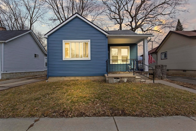 bungalow-style home featuring a porch and a front yard