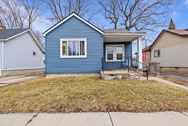 bungalow with a porch and a front lawn