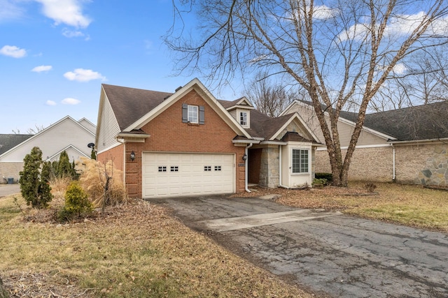 traditional-style house with a garage, stone siding, aphalt driveway, roof with shingles, and brick siding