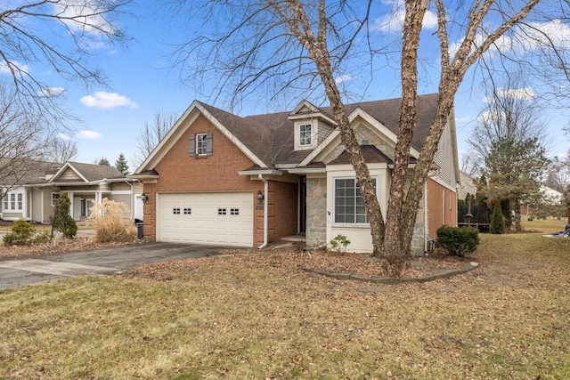 view of front of house featuring a garage, stone siding, aphalt driveway, a front lawn, and brick siding