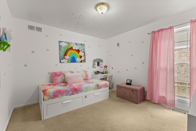 bedroom with baseboards, visible vents, and light colored carpet